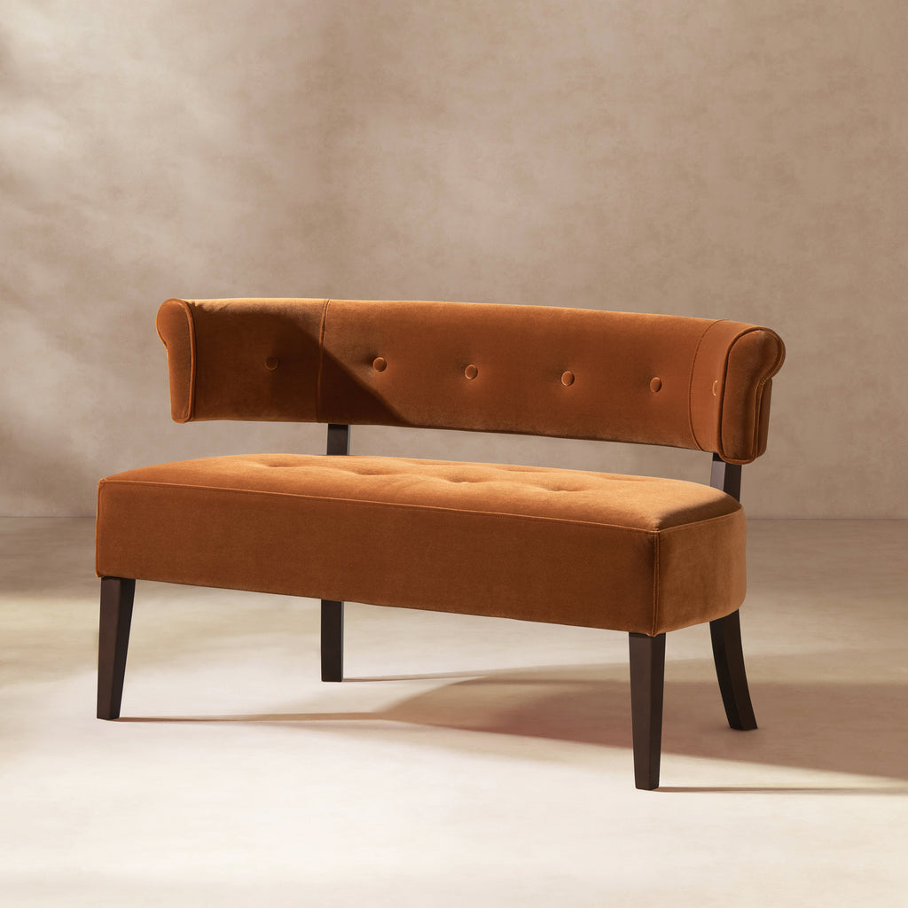 Burnt Orange Velvet Bench Settee with button-tufted seat and back, displayed in a minimalist studio setting.