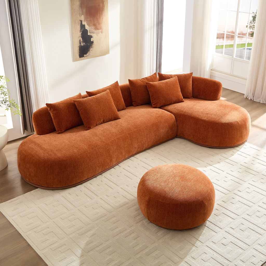 Oversized orange L-shape sectional sofa with ottoman in a sunlit room, offering deep seating and modern comfort.