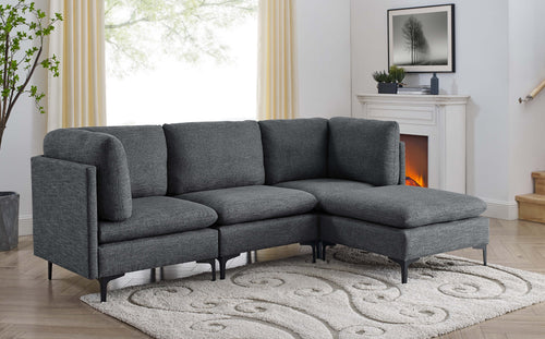 Modern charcoal grey linen modular sectional sofa with plush cushions and sleek black metal legs in a living room.