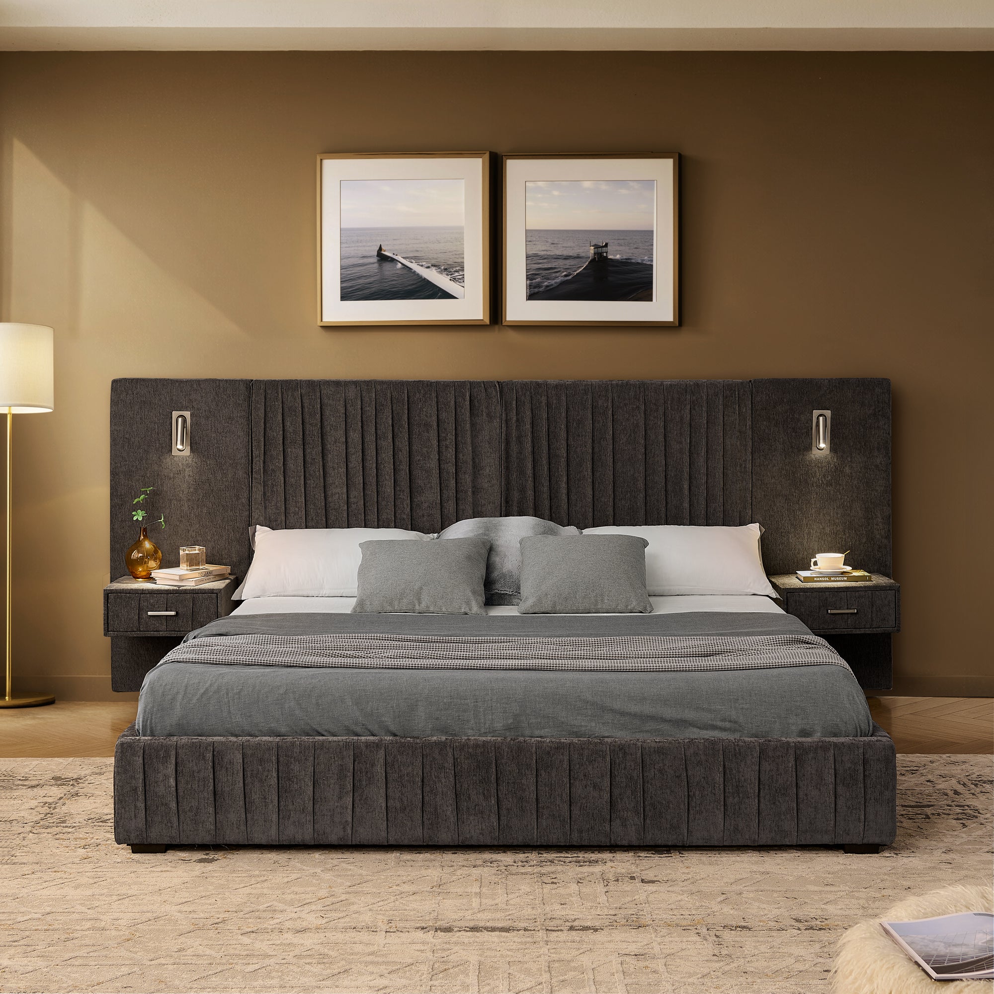 Front view of queen upholstered bed with built-in bedside tables and lamps. Solid frame and pleated headboard add luxury to bedroom decor.