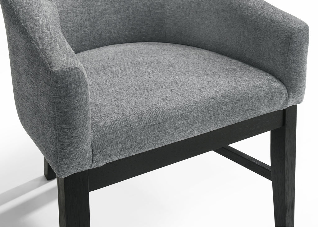 Close-up of Haven 7Pc Dining Set - Round Ebony chair seat showing textured gray upholstery and solid black wood frame for modern elegance.