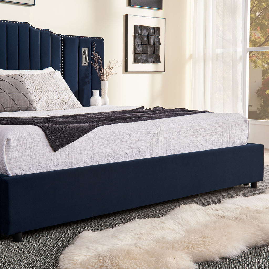 Side view of queen velvet bed frame with under-bed storage and soft white bedding in a cozy, modern bedroom.