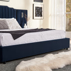 Side view of queen velvet bed frame with under-bed storage and soft white bedding in a cozy, modern bedroom.