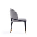 Side profile of Modern Grey Dining Chair with Metal Base showing curved backrest and sleek black legs with gold accents for a chic look.