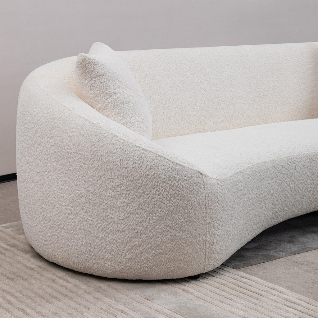 Close-up of the backrest and armrest curve on modern white sofa, showcasing its elegant minimalist design.