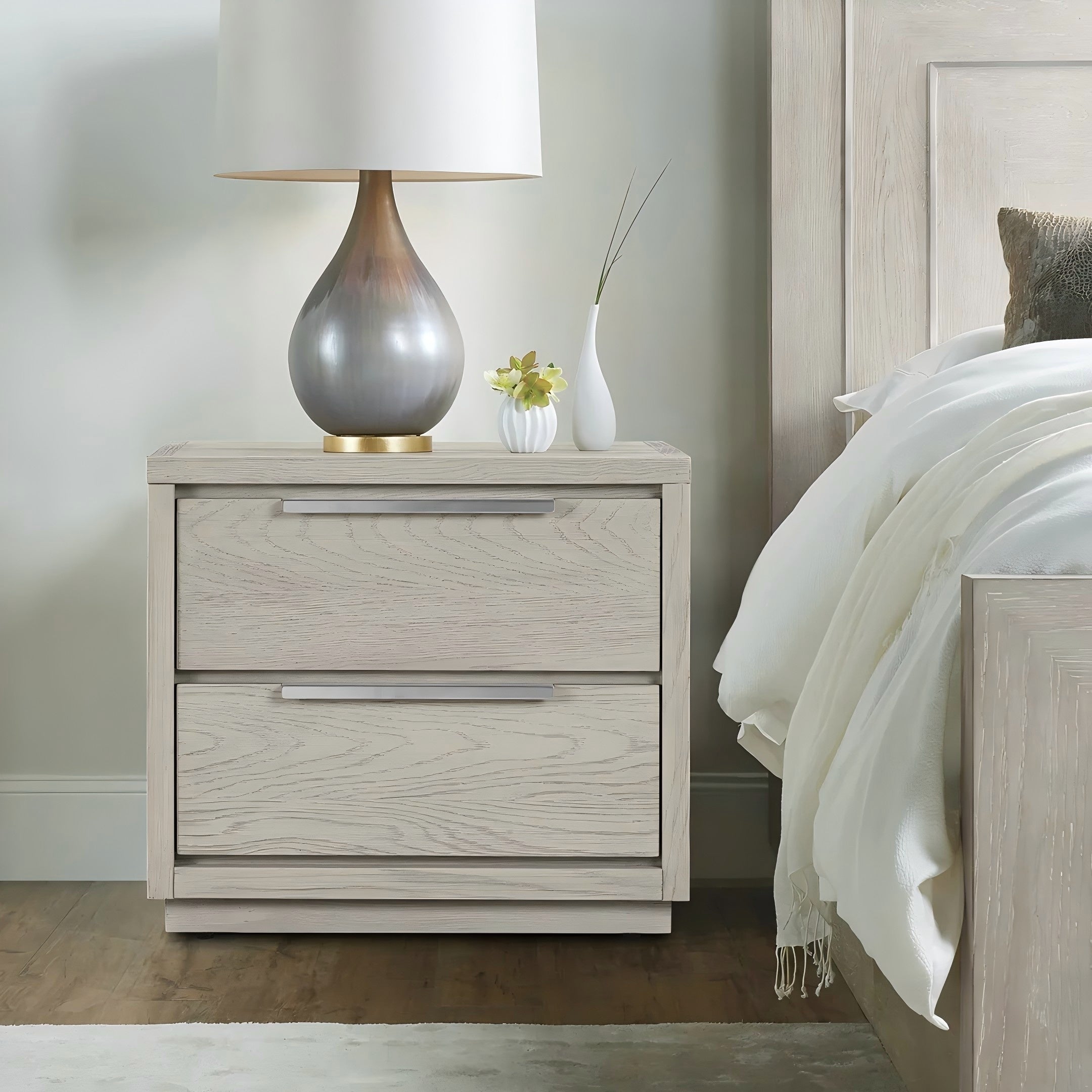 Modern two-drawer nightstand in gray oak wood with clean lines and sleek silver horizontal hardware.