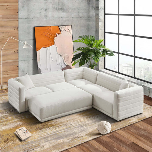 Cream boucle corner sectional sofa with matching ottoman, featuring a modern ribbed design in a bright living space.
