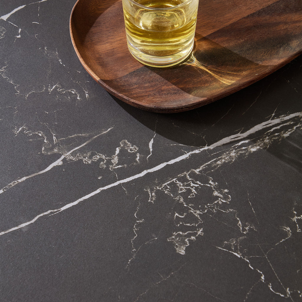 Close-up of the black sintered stone tabletop with white veining, part of the modern 35.43'' round coffee table design.