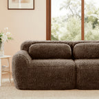 Close-up of 114'' modular sofa in chocolate plush fabric, showing soft backrest and armrest in a cozy room setting.