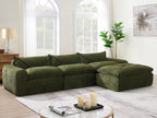 116'' compressed sofa with high density foam in green, styled with candles and coffee table in a bright, modern living space.