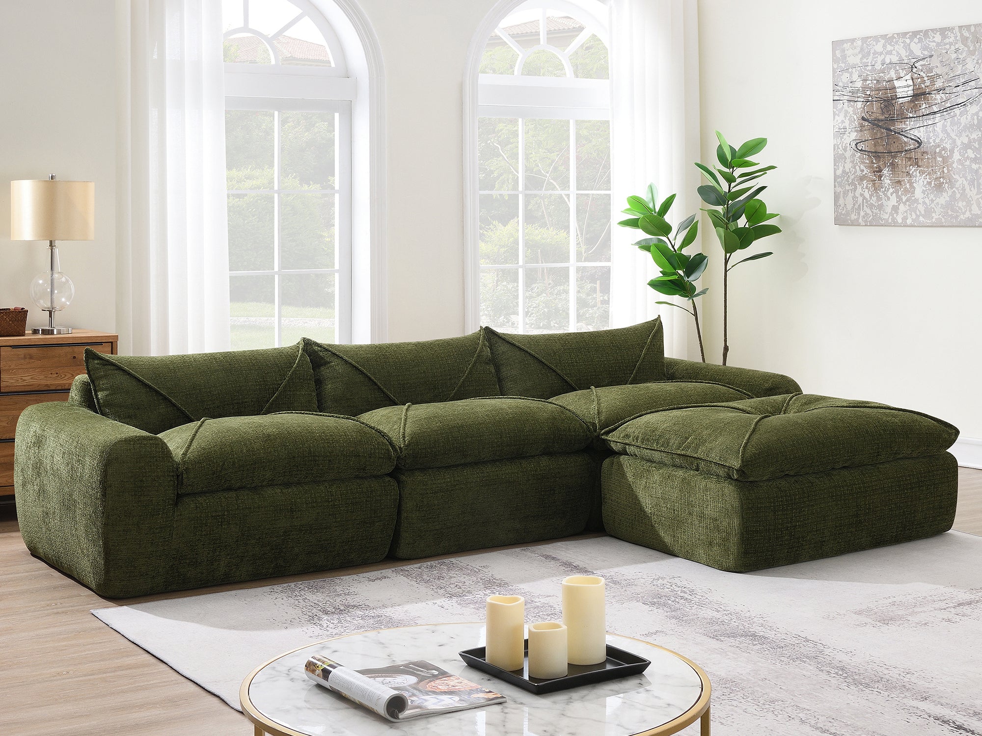 116'' compressed sofa with high density foam in green, styled with candles and coffee table in a bright, modern living space.