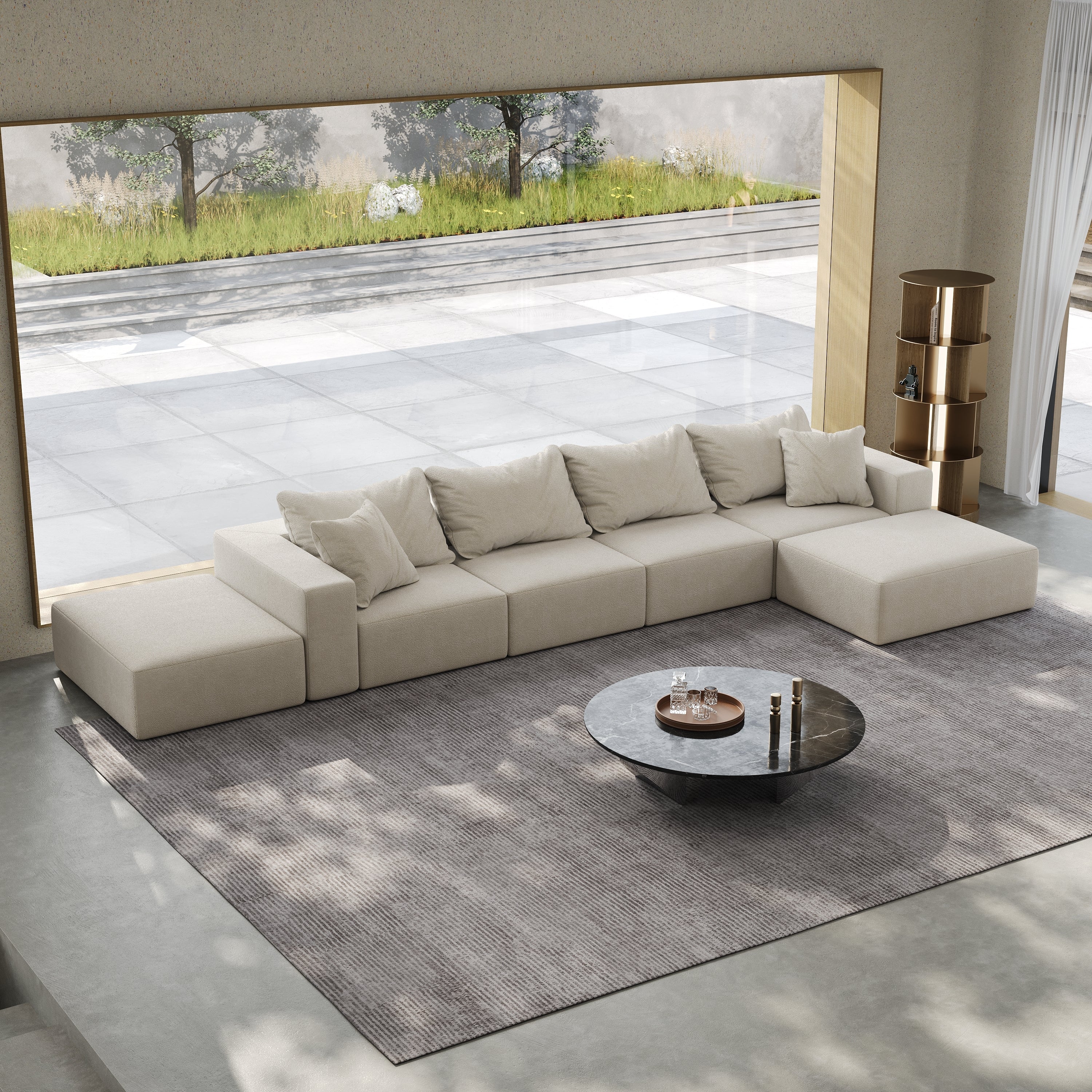 Modular beige L-shaped sectional sofa with plush cushions in a modern living room with a round stone coffee table.