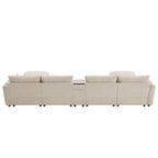 Back view of 136'' modular sectional sofa in beige with center console. Designed for comfort, storage, and tech-friendly living spaces.