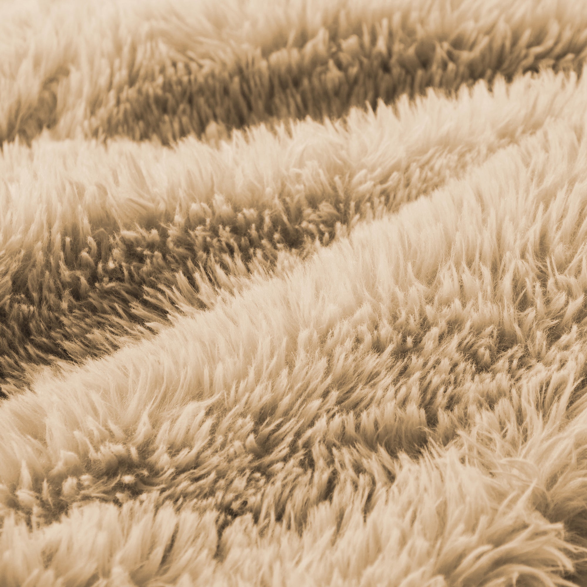 Close-up of ultra-soft plush fabric used in the light khaki modular sofa, emphasizing comfort and luxurious texture.