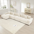 Oversized L-shape cream corduroy sectional with deep seats, wide armrests, and multiple matching throw pillows.