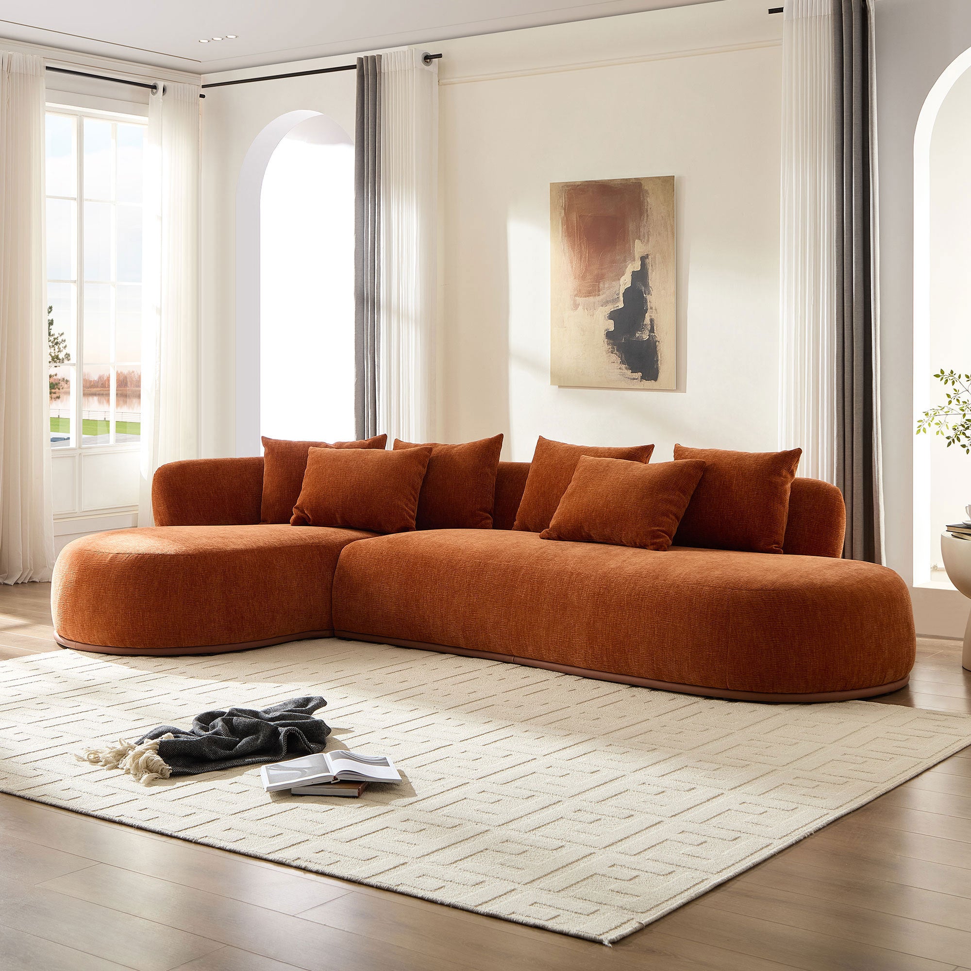Plush modern L-shape sectional sofa with deep seat and chaise in burnt orange, styled in a bright living space with neutral decor.