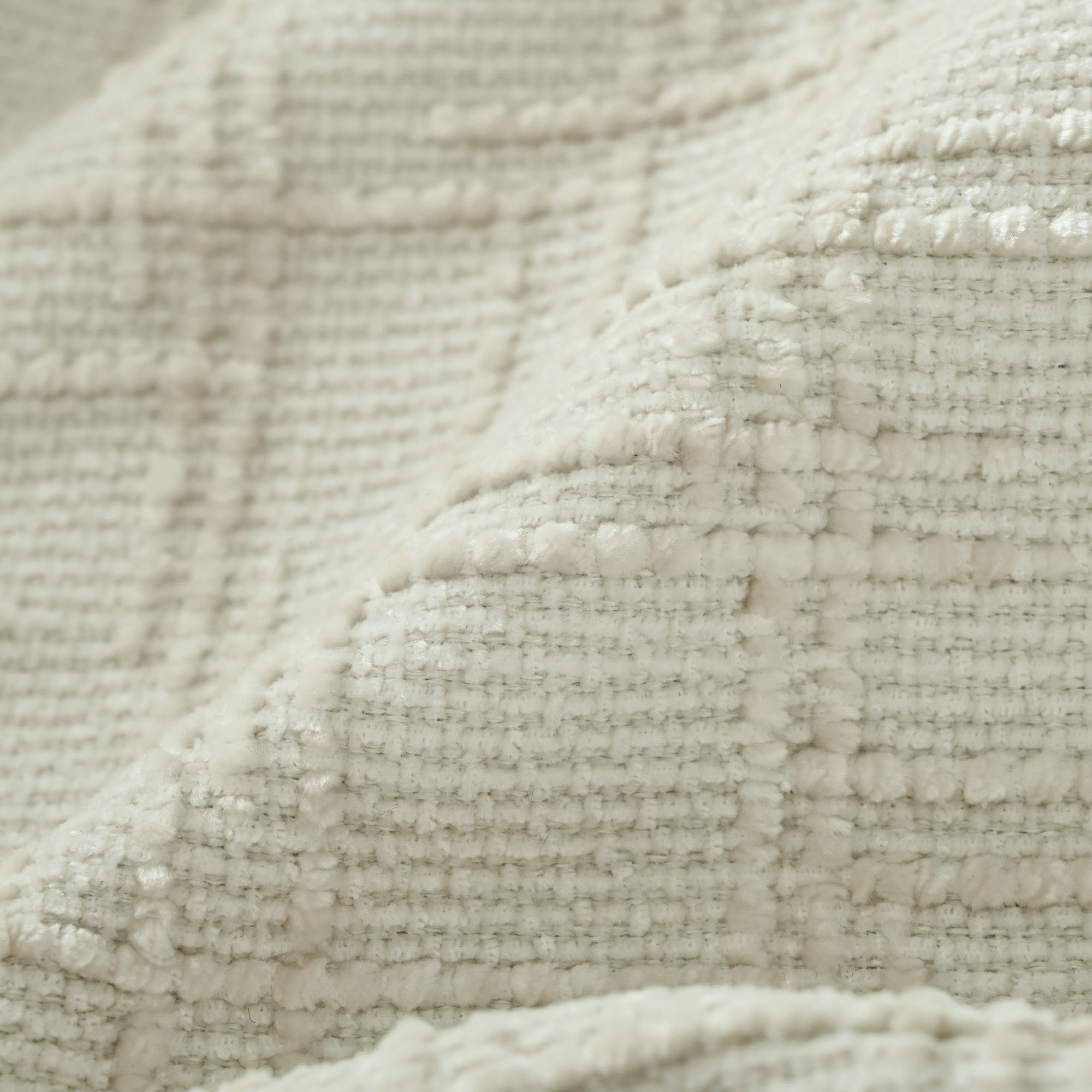 Textured chenille fabric detail of the U-shaped sectional sofa with ottoman, highlighting soft and durable weave.