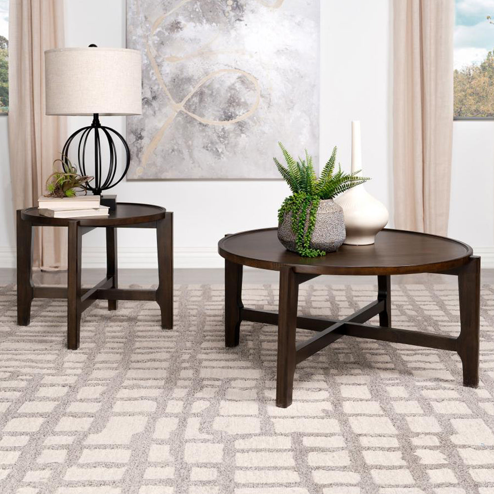 Dark brown solid wood end table paired with matching coffee table in a modern living room, emphasizing cohesive round design.