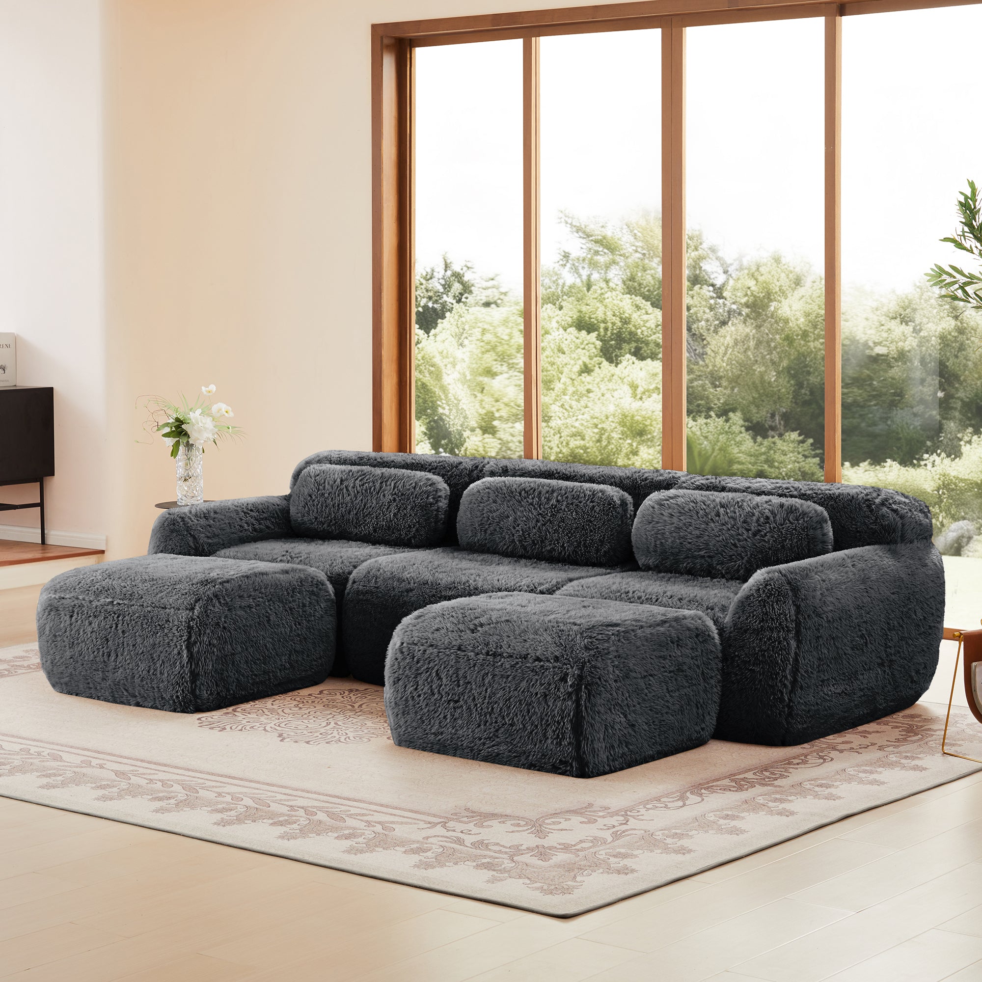 Dark grey modular sofa with chaise in boneless design, shown in a cozy home setting. Plush fabric and anti-slip base ideal for lounging.