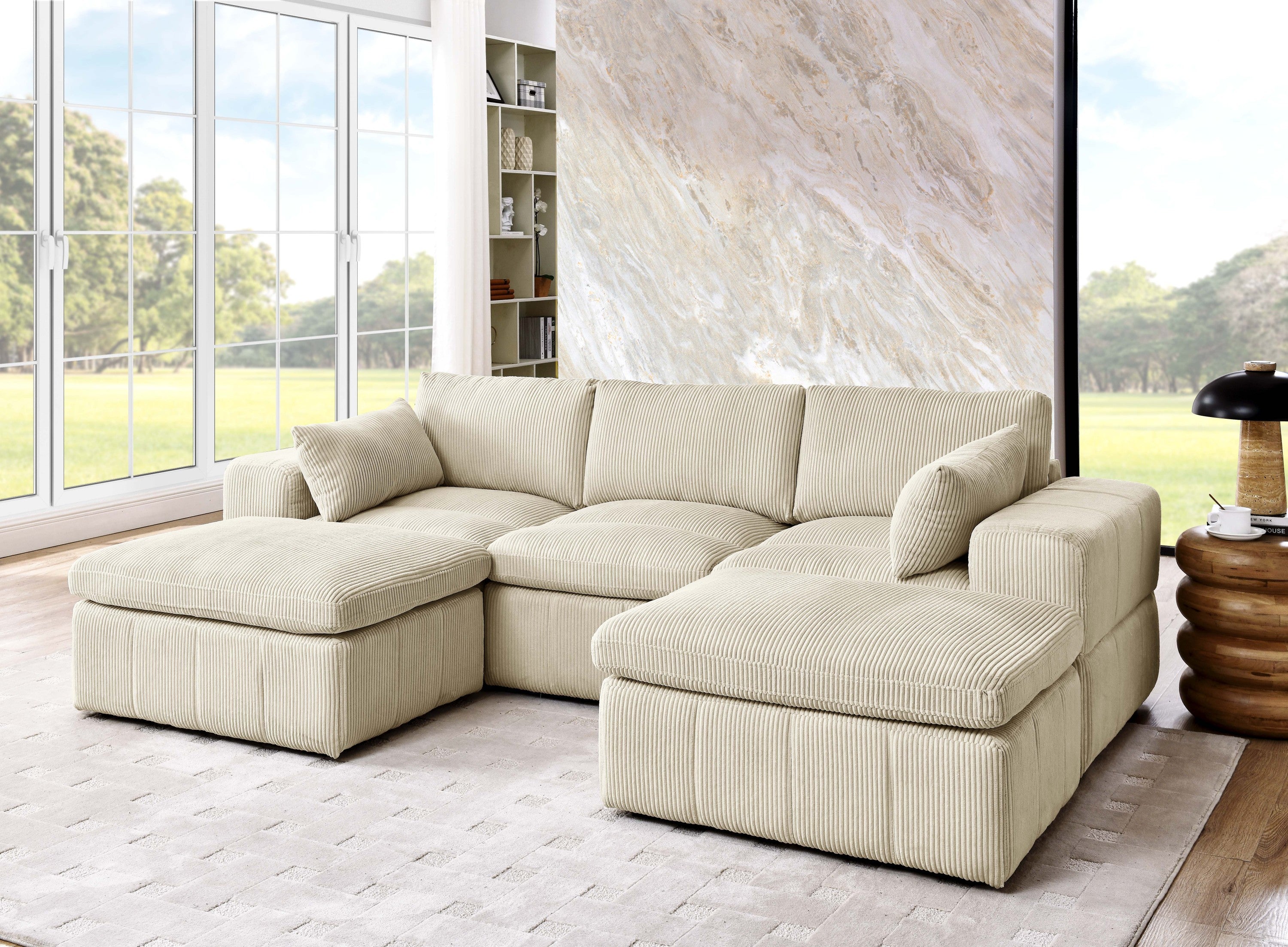 Beige corduroy sectional with ottomans and large arms in a modern living room. Custom configuration with toss pillows and durable upholstery.