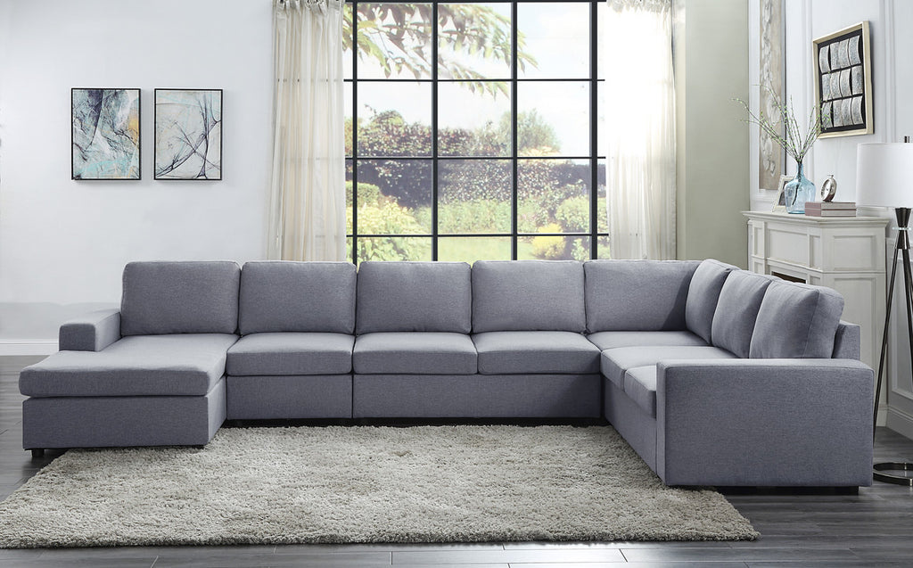 Large light gray linen modular sectional sofa with seven seats and a reversible chaise in a modern living room.