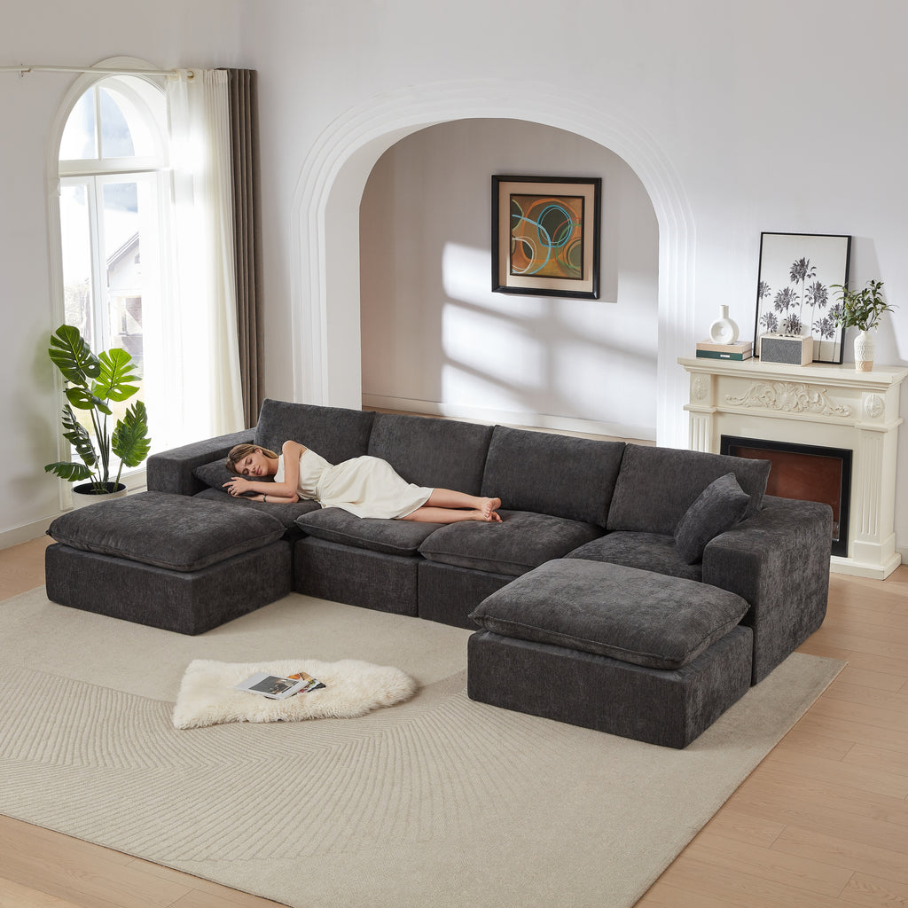 Chenille Cloud Sofa in dark gray with a woman sleeping on it, highlighting its comfort and spacious modular layout for modern interiors.
