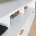 Close-up of open shelf in White Coastal Credenza, displaying decorative items and books, ideal for stylish media storage.