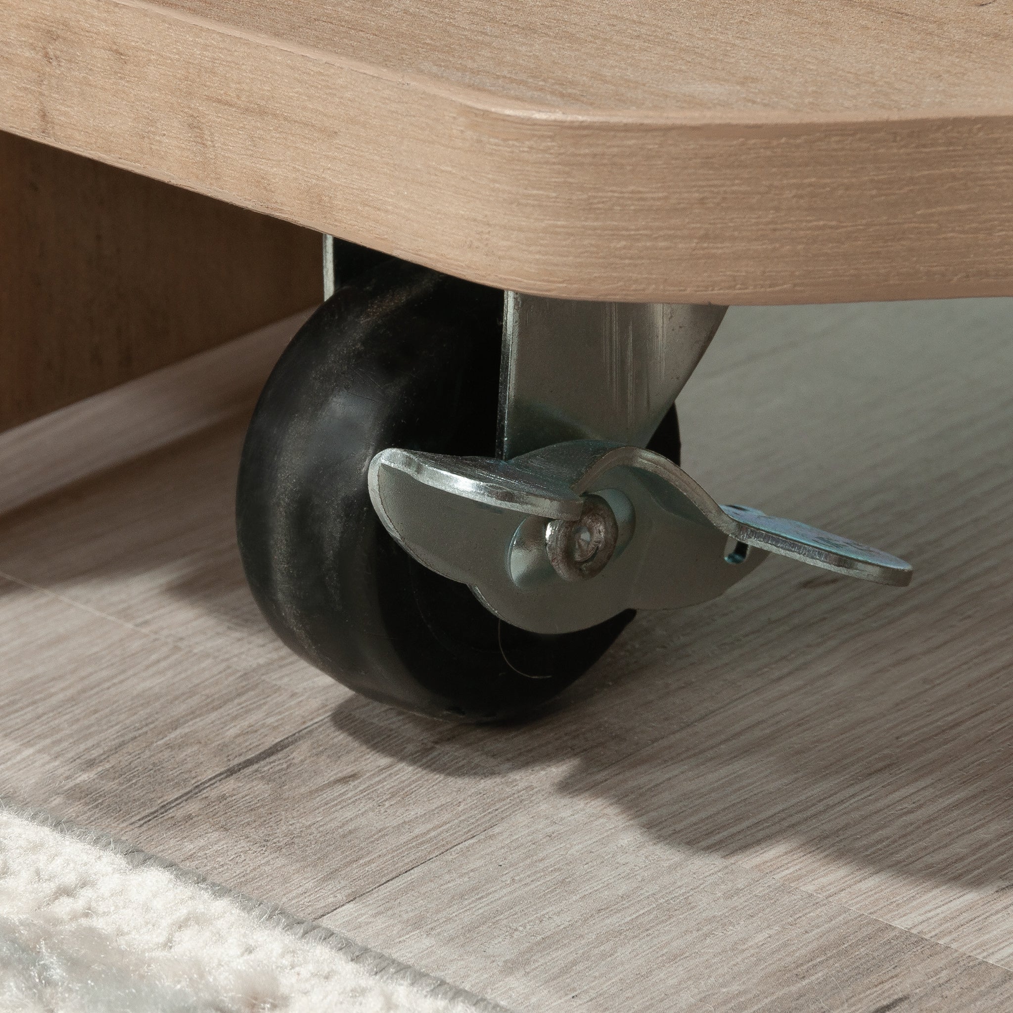 Close-up of locking caster on Craft Cart with Storage for Home, enabling easy mobility and secure workstation setup.