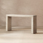 Whitewashed reclaimed pine console table featuring a minimalist geometric waterfall design with stacked, ribbed legs.