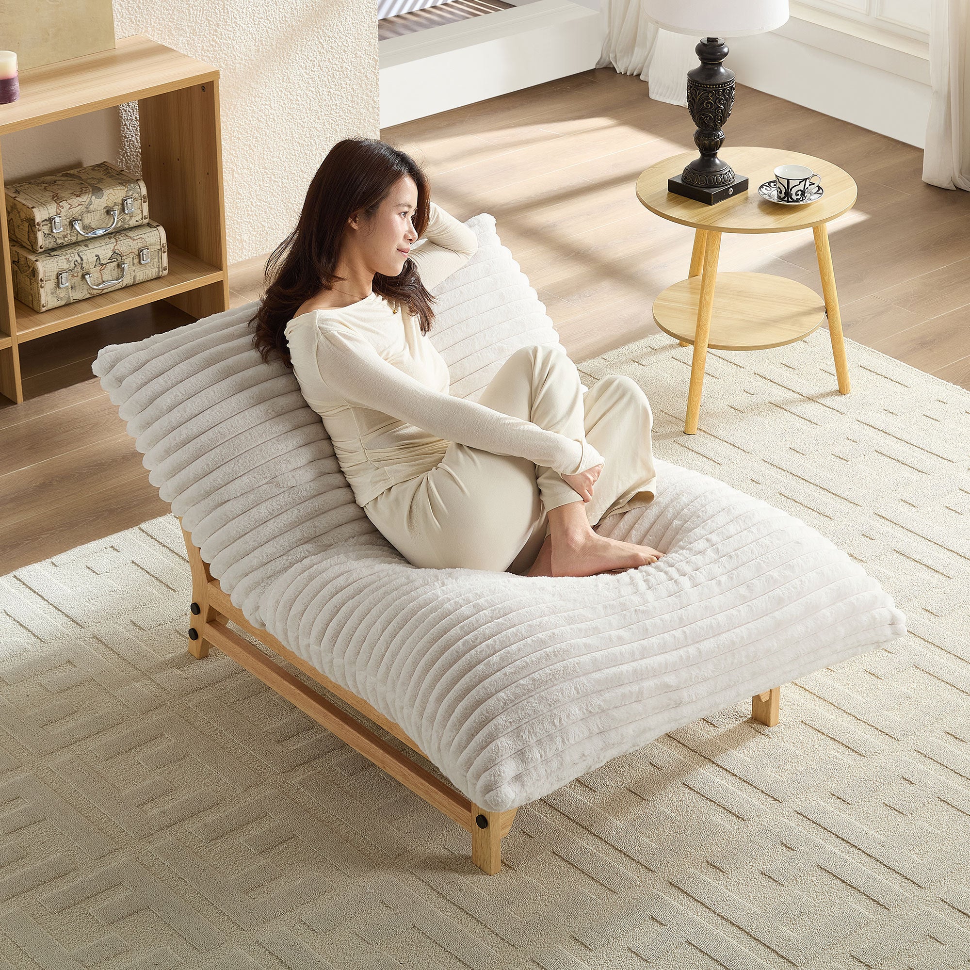 Woman lounging on Corduroy Armless Lazy Sofa in a cozy living room, highlighting its comfort and suitability for relaxation or reading.