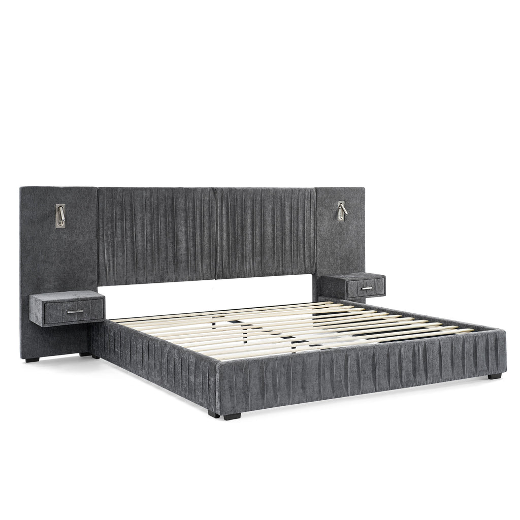 Angled view of queen upholstered bed frame with slats. Features built-in bedside tables, lamps, and pleated headboard on solid frame.