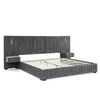 Angled view of queen upholstered bed frame with slats. Features built-in bedside tables, lamps, and pleated headboard on solid frame.