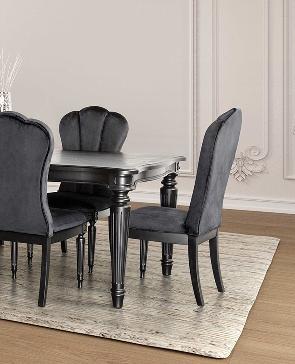 Black dining room side chairs with fluted legs arranged around a dark wood table in a classic interior setting.