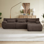 Modern L-shaped modular sectional sofa in dark brown textured fabric with oversized, boneless cushions on a neutral rug.