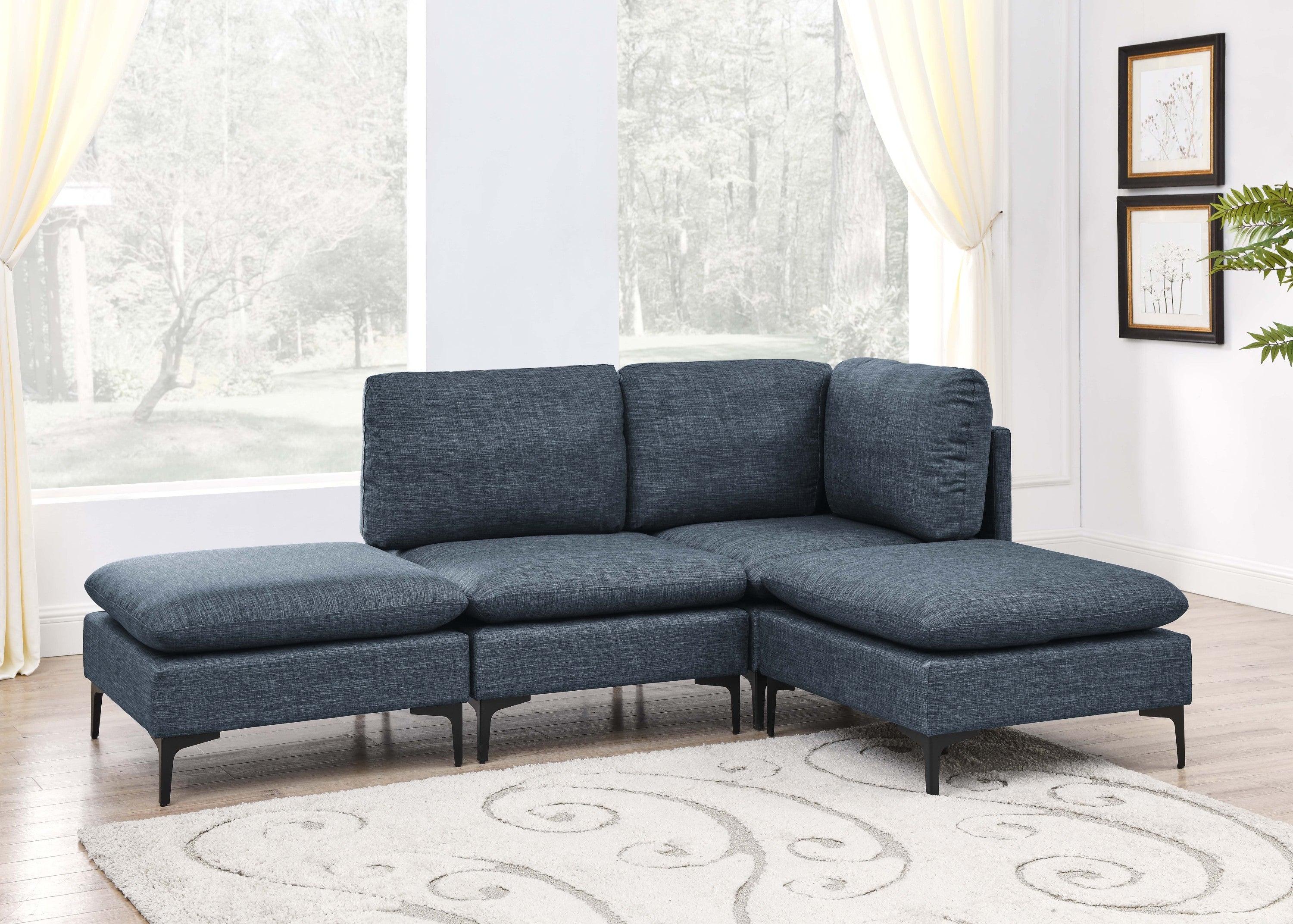 Modern navy blue linen modular sectional sofa featuring plush cushions and sleek black metal legs in a bright living room.