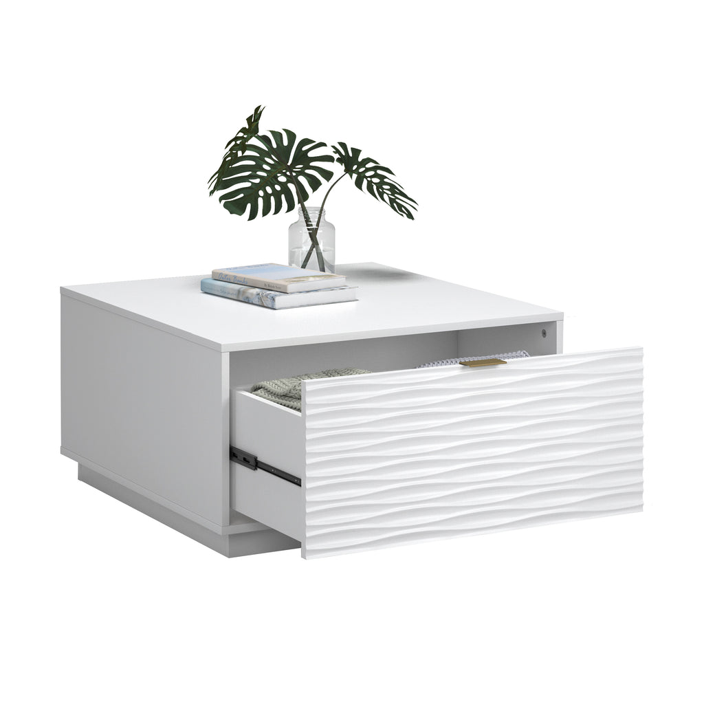 White coffee table with drawer open, styled with books and greenery, combining storage and decor in coastal design.