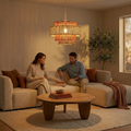 Tiered, woven terracotta and natural fiber pendant lamp hanging above a couple on a sofa in a warm, modern living room.