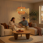 Tiered, woven terracotta and natural fiber pendant lamp hanging above a couple on a sofa in a warm, modern living room.
