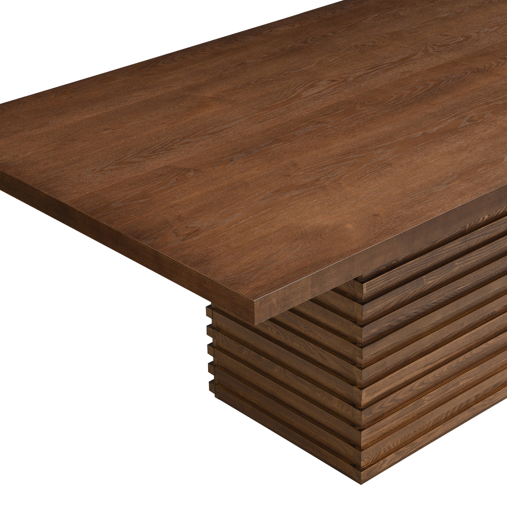 Close-up of Coad 84-inch Walnut Dining Table corner showing thick walnut tabletop and detailed wood grain texture.