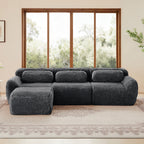 Dark Grey Plush Modular L-Shaped Sofa with Ottoman shown front-facing, highlighting its ergonomic backrest and deep seating on a patterned rug.