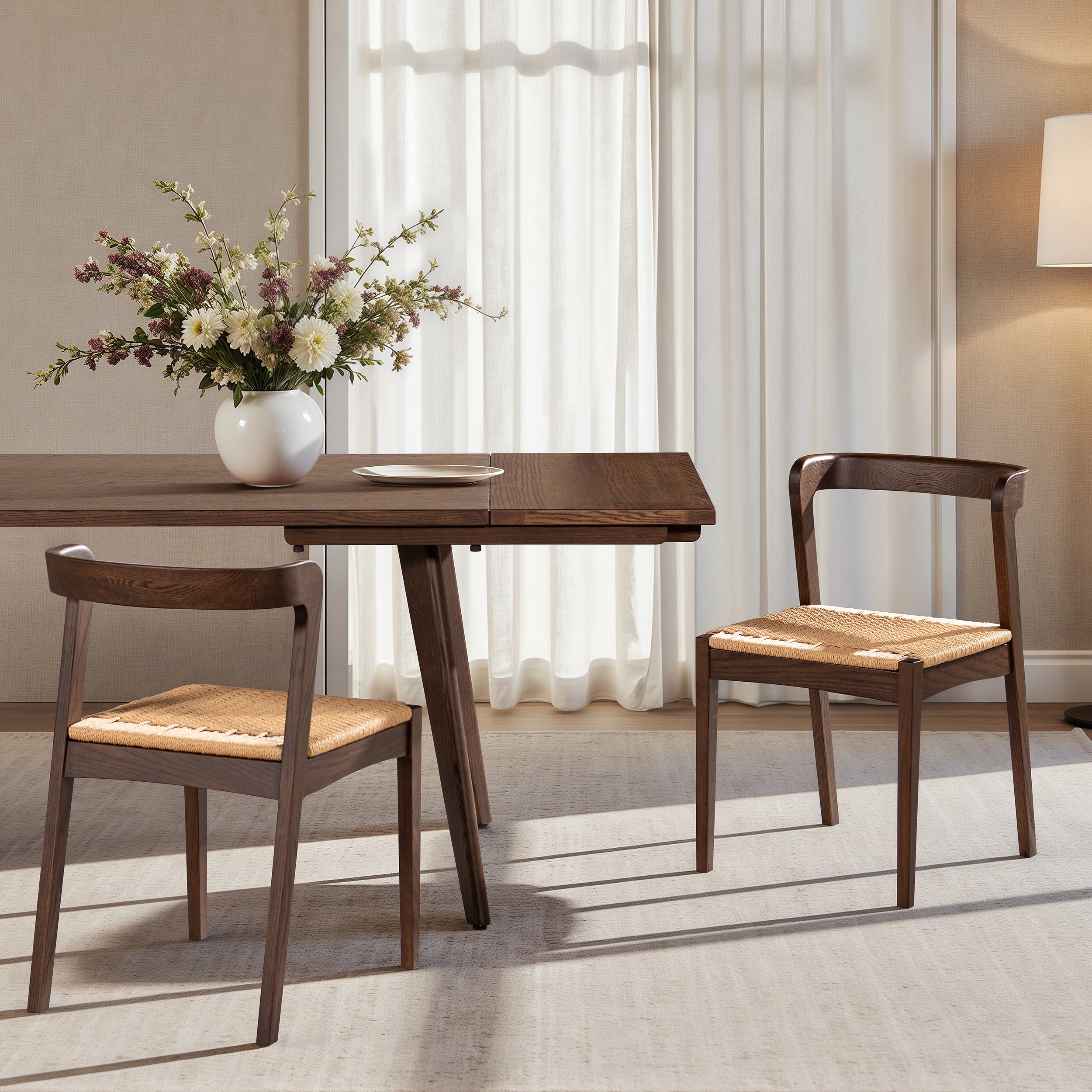 Capri Oak Wood Dining Chair in Dark Brown Red Oak placed at a dining table with floral centerpiece, showcasing its woven seat and curved backrest.