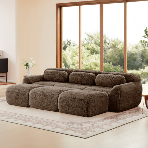 3-seater chocolate modular plush sofa with ottoman, shown in spacious room with large windows and natural light.