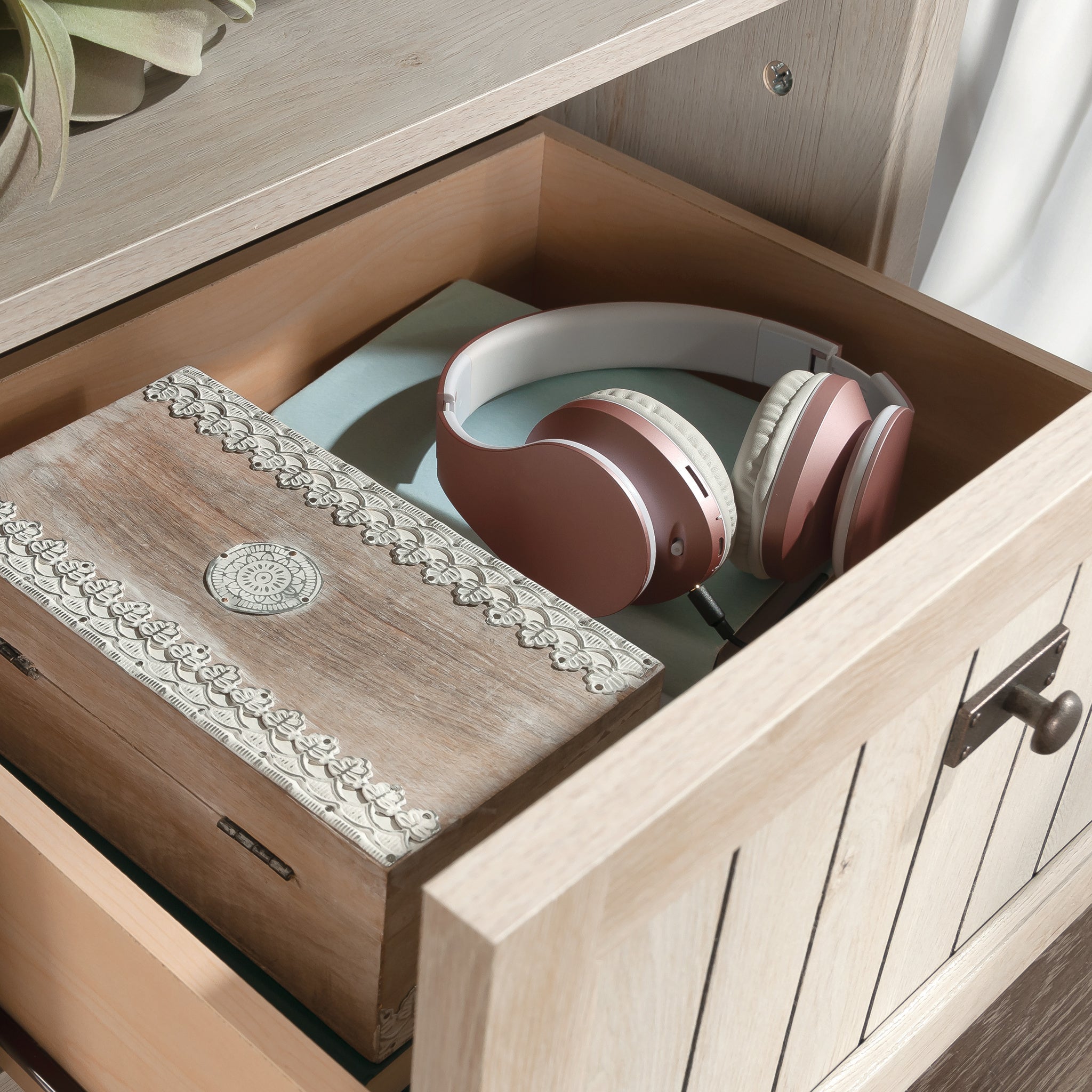 Close-up of drawer interior in Gray Night Stand with Drawer, showcasing storage space for headphones and decorative box.