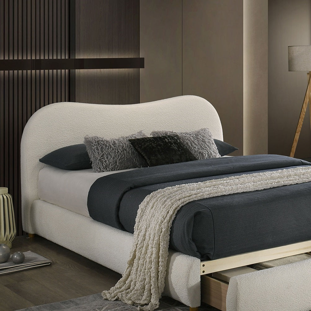 Detail view of curved headboard on Velvet King Size Bed, paired with textured pillows and cozy bedding in a modern interior.