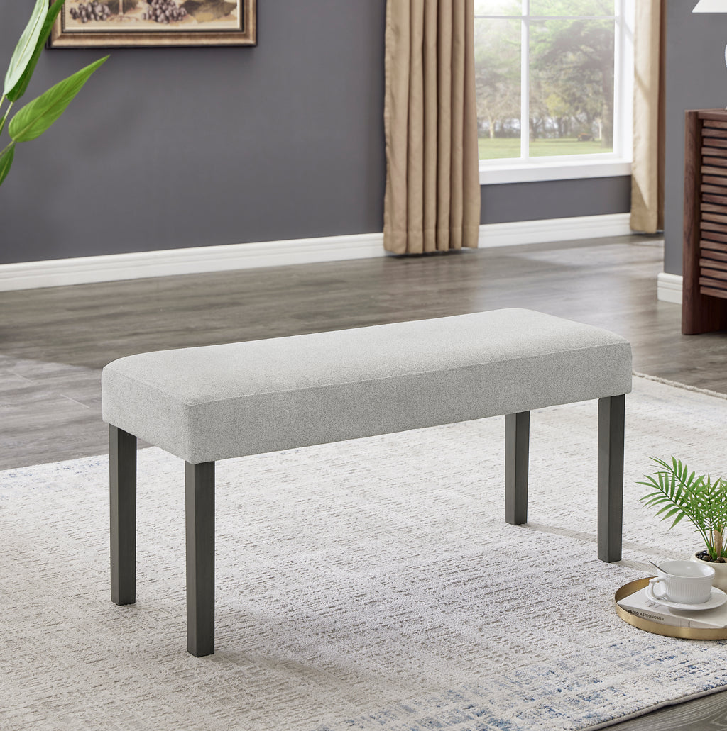 Upholstered dining bench from Selena Dining Set in light gray fabric with dark legs, perfect for seating up to two people.