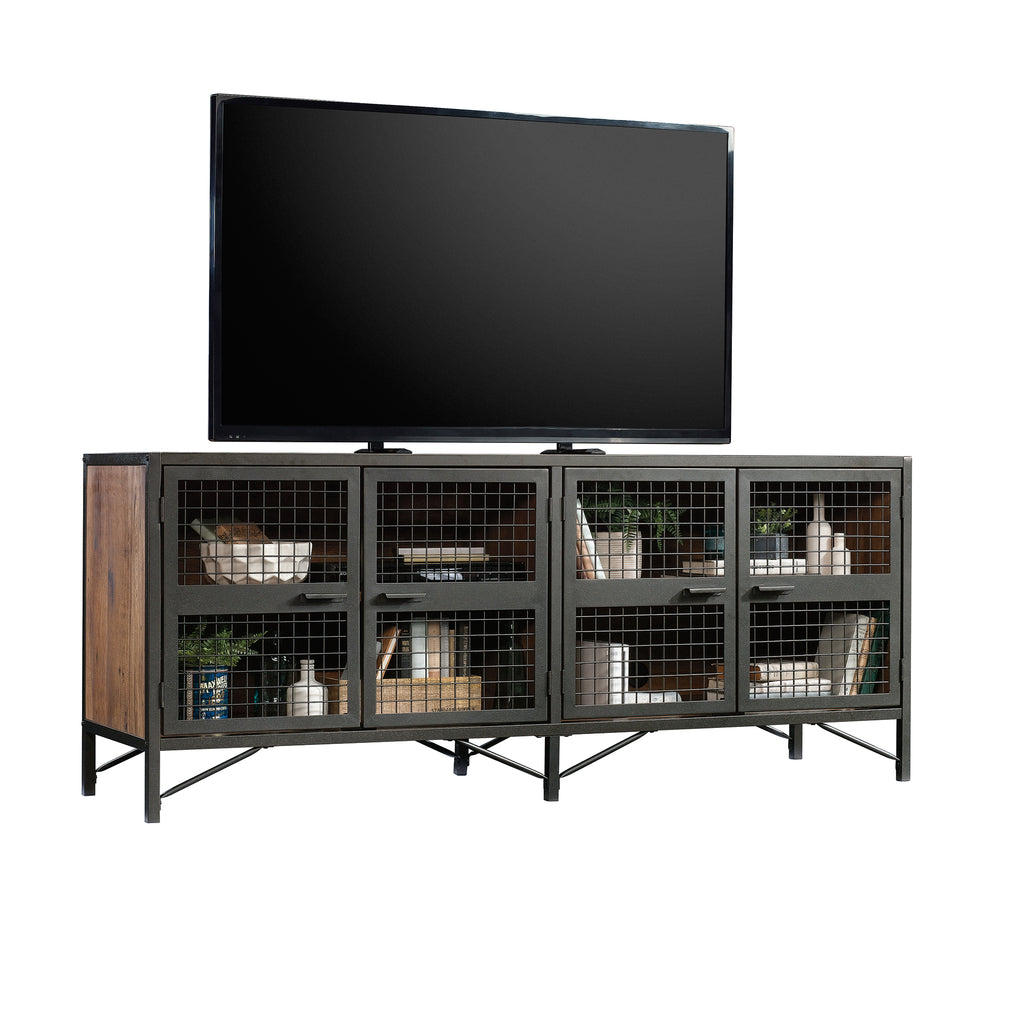 Industrial Brown TV Credenza supporting a flat-screen TV, featuring six mesh doors and spacious shelving for media accessories.