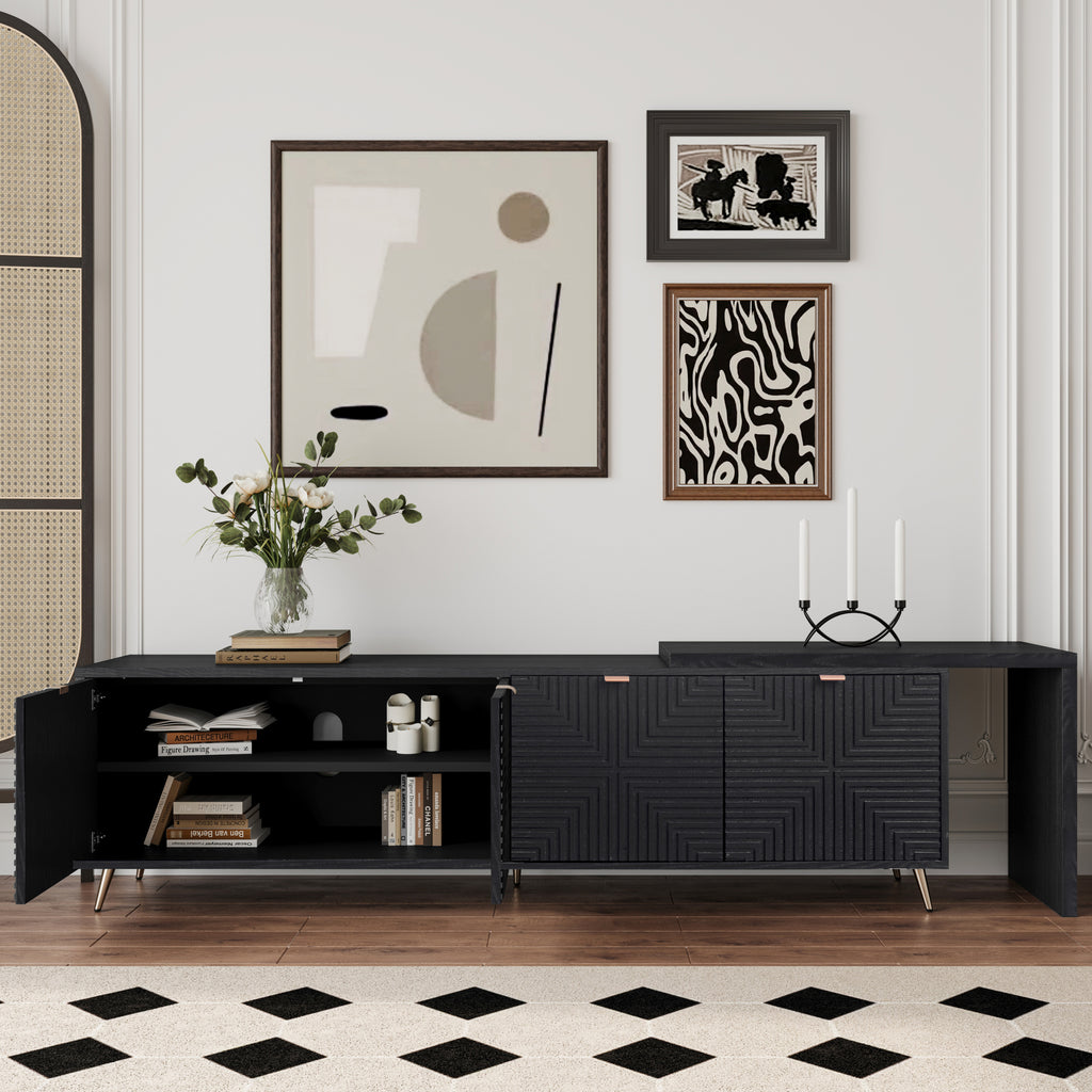 Black lacquered and wood veneered entertainment center with open shelving and adjustable compartments, displayed with wall art and books.