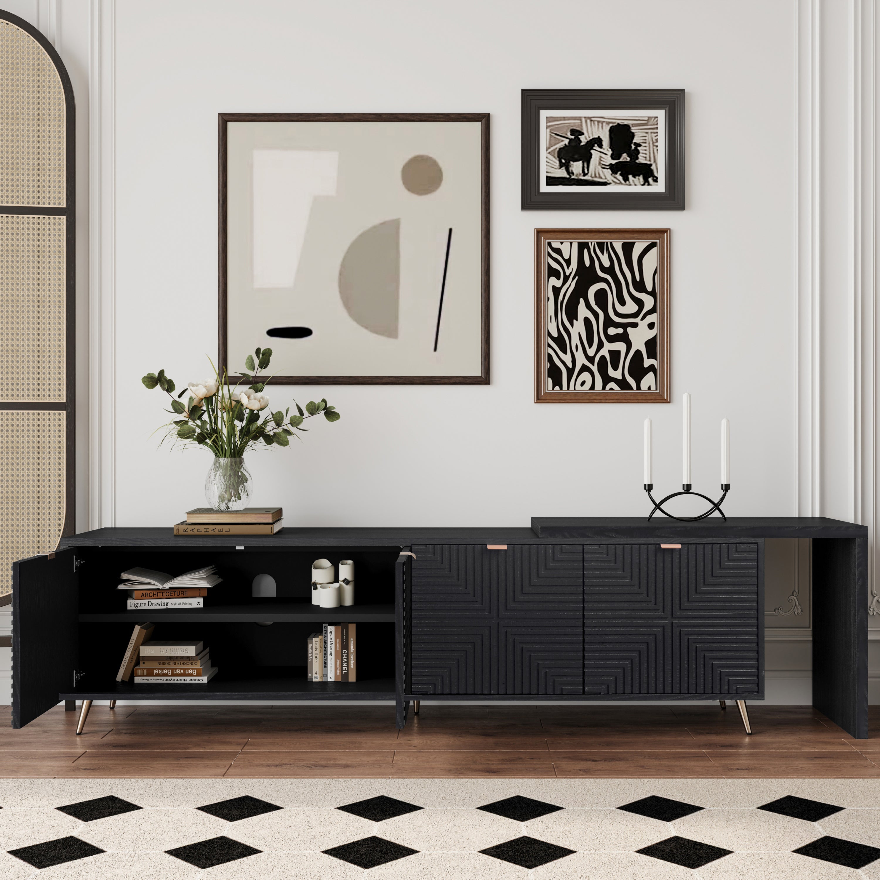 Black lacquered and wood veneered entertainment center with open shelving and adjustable compartments, displayed with wall art and books.