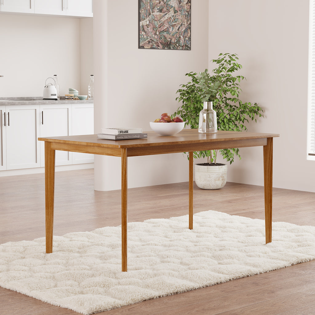 Solid wood dining table with tapered legs in a modern kitchen. Showcases clean lines and a smooth, durable surface.