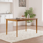 Solid wood dining table with tapered legs in a modern kitchen. Showcases clean lines and a smooth, durable surface.
